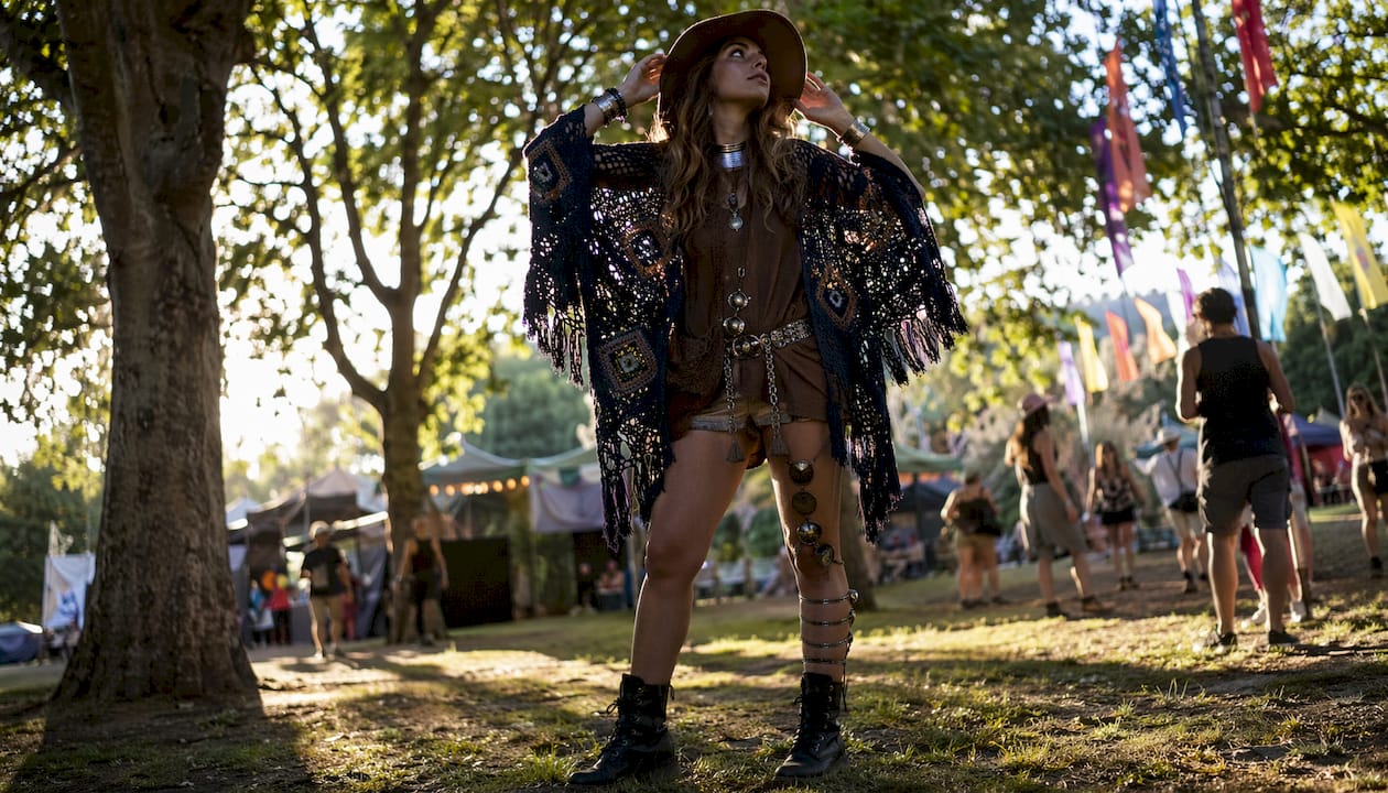 Woman wearing festival-themed layered outfit outdoors