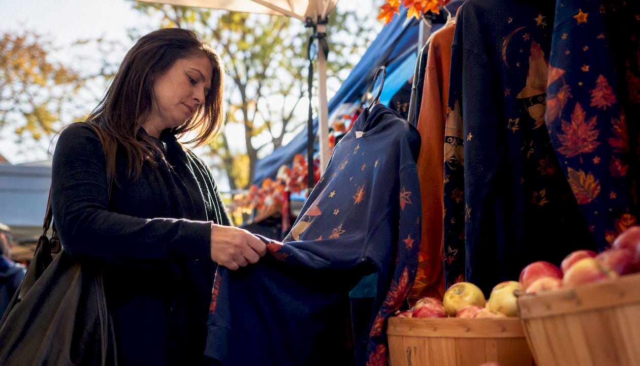Shopper examining fall seasonal hoodie